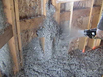 Loose-Fill Cellulose being blown into an unfinished wall.