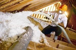 White blown-in attic insulation being installed in Fresno, CA.