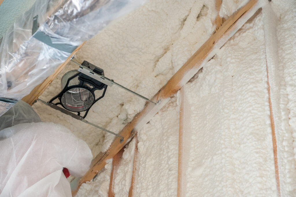 Spray foam insulation being installed in a wall
